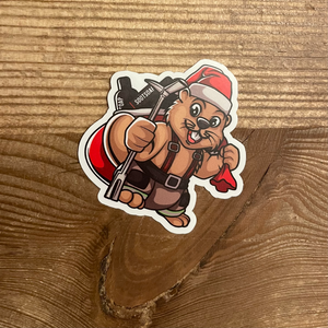 Beaver dressed as a firefighter with a santa hat holds a hallogen and a sac full of SOOTSOAP personal decon bottles