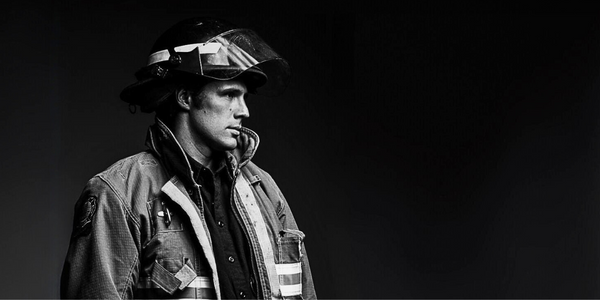 A black and white image of a firefighter needing to decontaminate